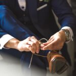 man ties his dress shoes