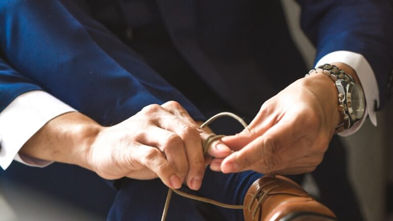 man ties his dress shoes